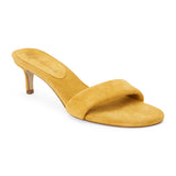 Yellow suede slide sandal with wide strap and low kitten heel, shown on a white background.