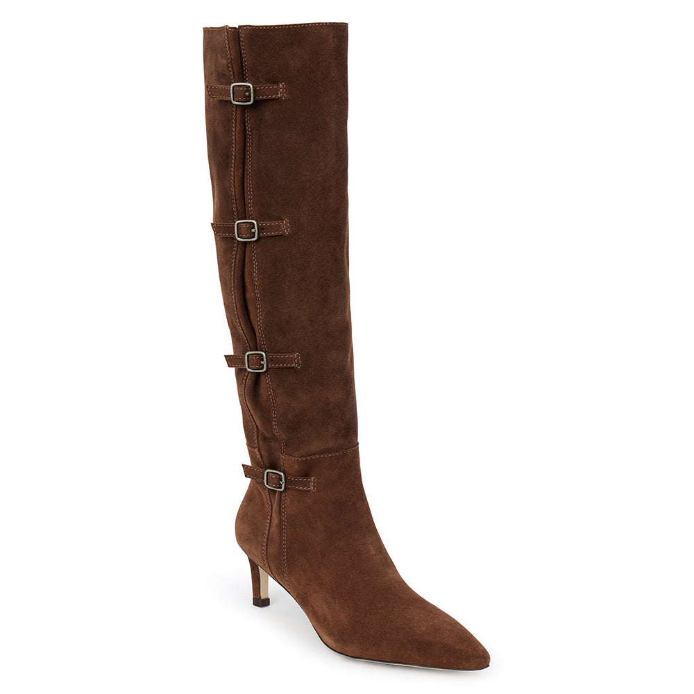 Brown suede knee-high boot with four silver-tone buckle accents, a pointed toe, and slim brown kitten heel shown on a white background.
