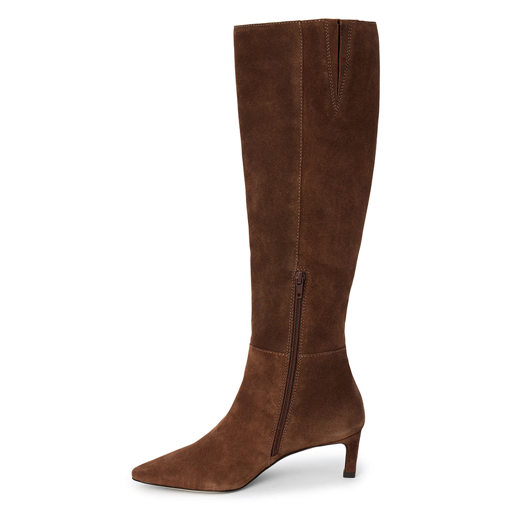 Brown suede knee-high boot with four silver-tone buckle accents, a pointed toe, and slim brown kitten heel shown on a white background.