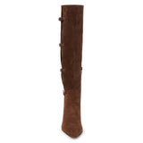 Brown suede knee-high boot with four silver-tone buckle accents, a pointed toe, and slim brown kitten heel shown on a white background.
