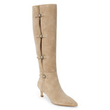 Tan suede knee-high boot with four silver-tone buckle accents, a pointed toe, and slim tan kitten heel shown on a white background.