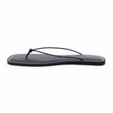 Black leather flat thong sandal with slim knotted straps and square toe, shown on a white background.