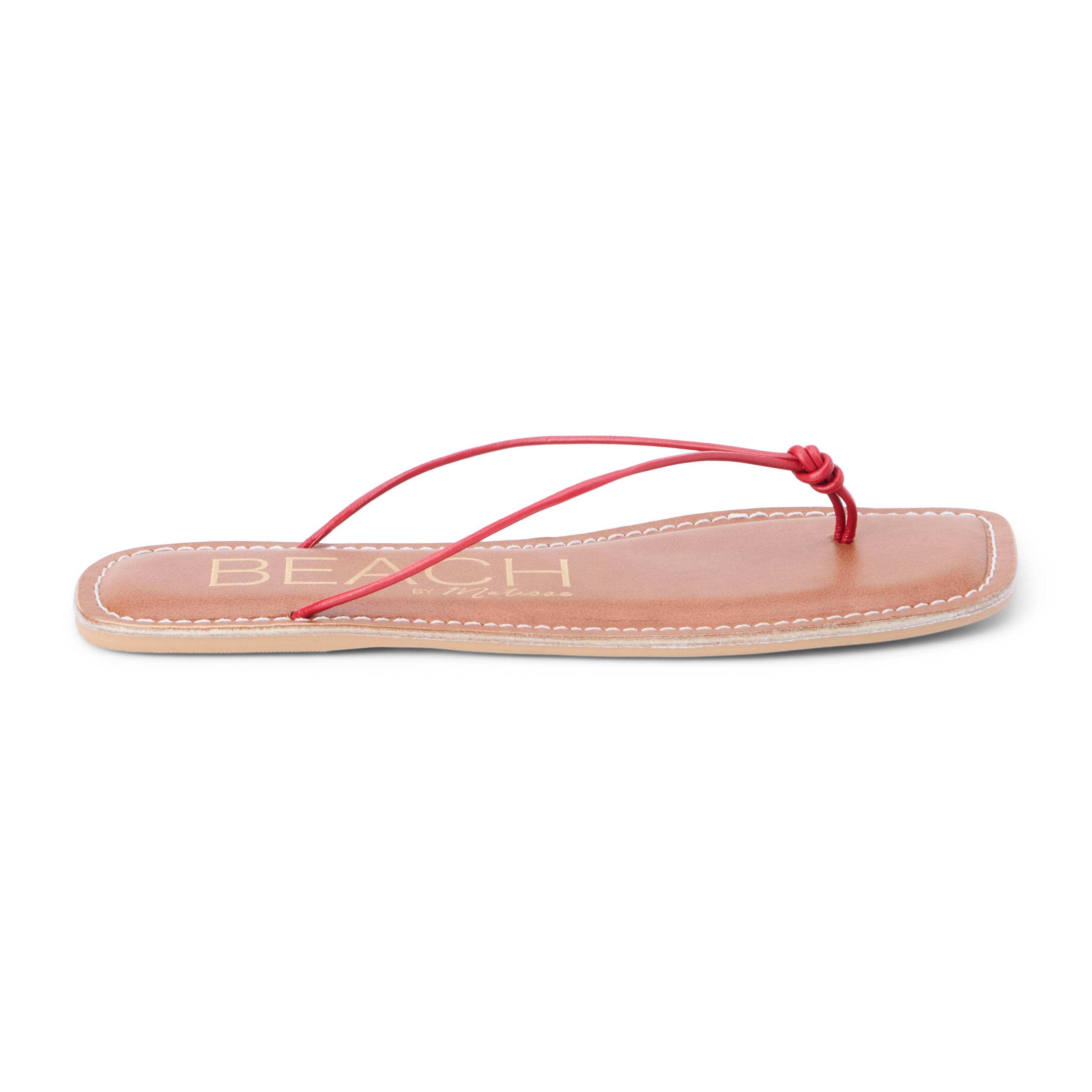 Red leather flat thong sandal with slim knotted straps and square toe, shown on a white background.