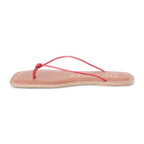 Red leather flat thong sandal with slim knotted straps and square toe, shown on a white background.