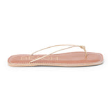 Metallic gold leather flat thong sandal with slim knotted straps and square toe, shown on a white background.