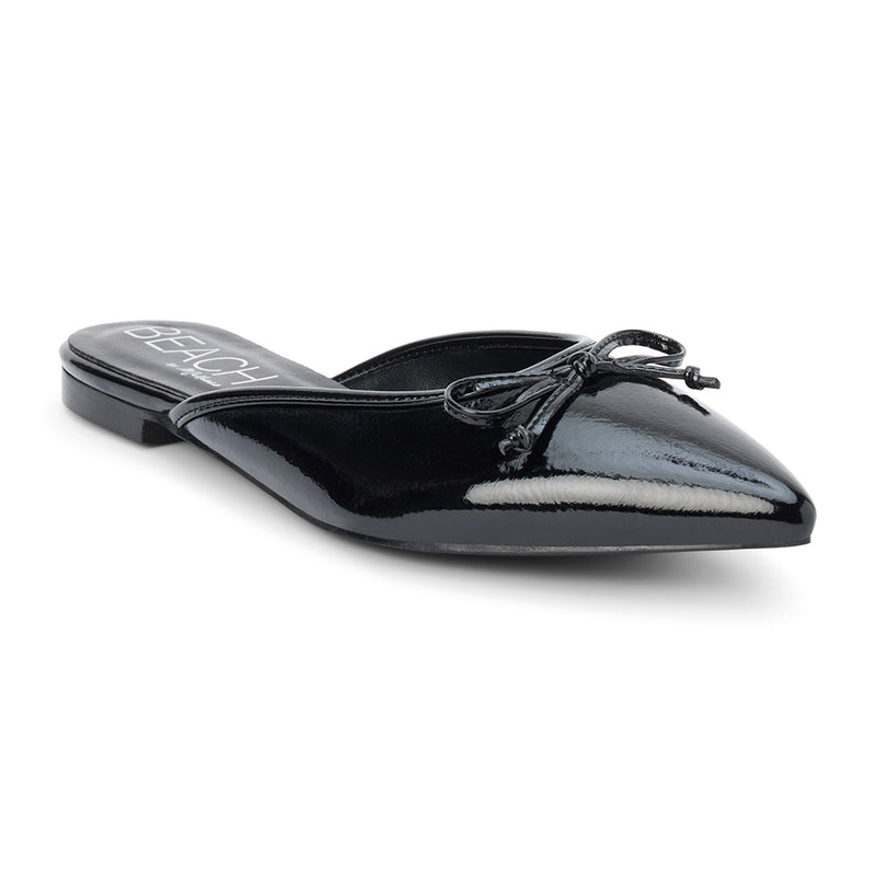 Reggie Vegan Pointed Toe Mule – Beach by Matisse – Black faux patent leather flat mule with pointed toe and petite bow detail.