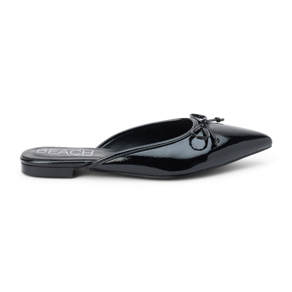 Reggie Vegan Pointed Toe Mule – Beach by Matisse – Black faux patent leather flat mule with pointed toe and petite bow detail.