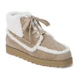 Vegan tan faux suede ankle boot with white faux-fur trim, wraparound lacing, a rounded moc toe, and lug sole shown on a white background.