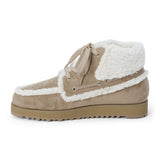 Vegan tan faux suede ankle boot with white faux-fur trim, wraparound lacing, a rounded moc toe, and lug sole shown on a white background.