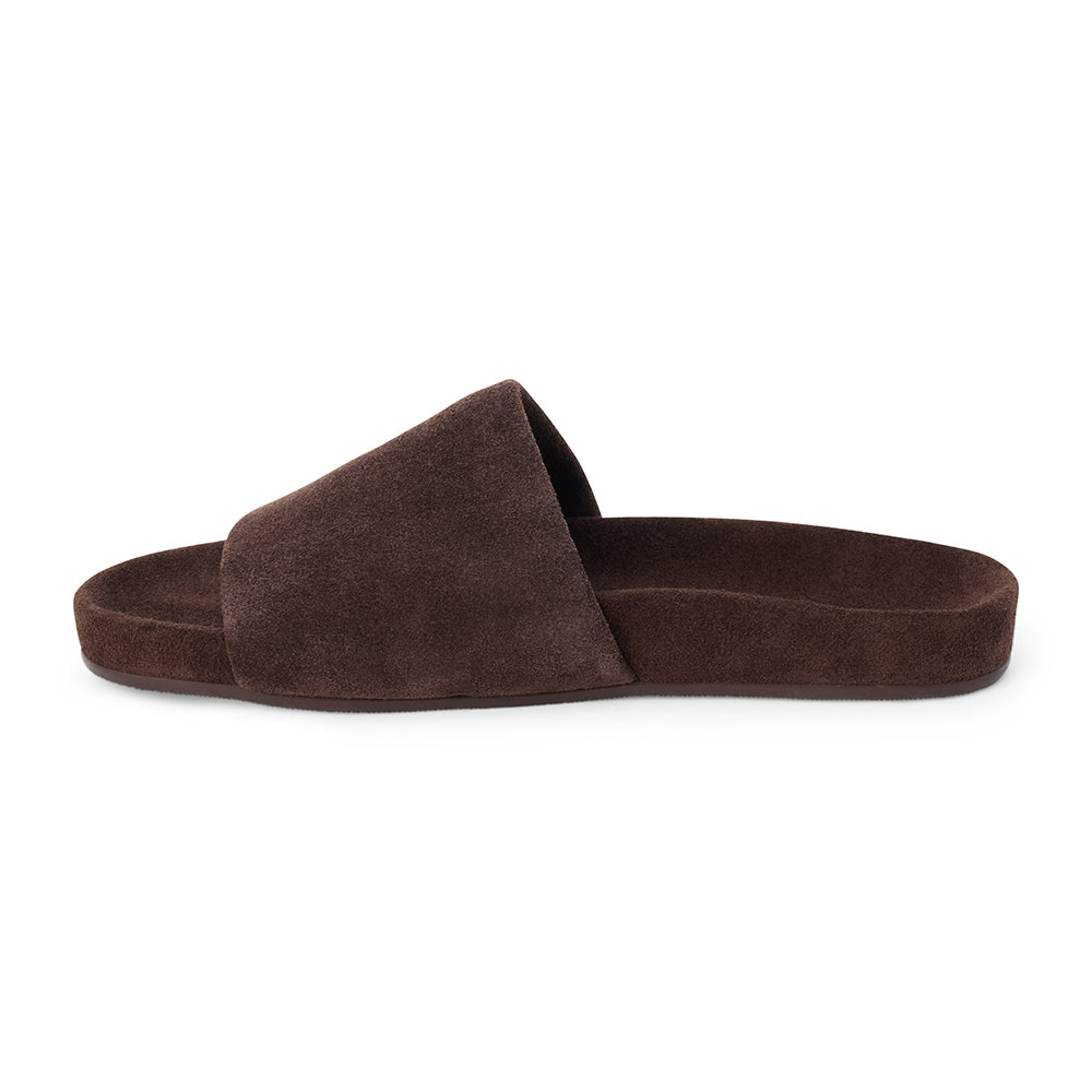 Espresso brown suede flat slide sandal with wide strap and molded footbed, shown on a white background.