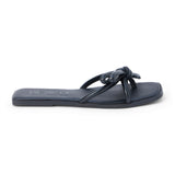 Black leather flat slide sandal with knotted straps and open toe, shown on a white background.