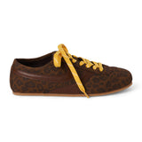 Vegan brown leopard-print faux suede sneaker with brown overlays, contrasting yellow laces, a rounded toe, and flat sole shown on a white background.