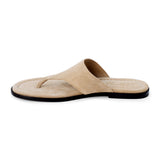 Sand beige suede flat thong sandal with wide strap and cushioned footbed, shown on a white background.