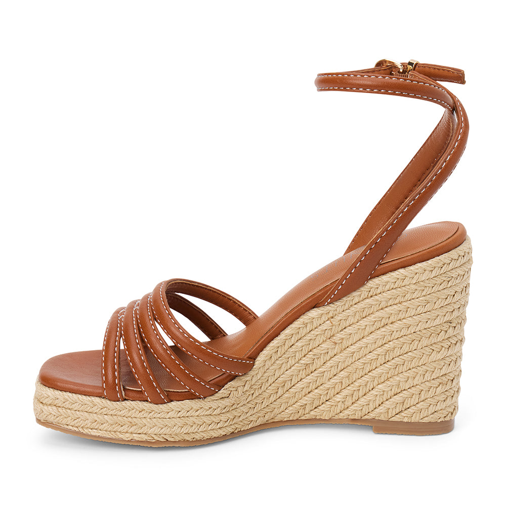 Brown vegan faux leather wedge sandal with ankle strap and braided platform heel shown on a white background.