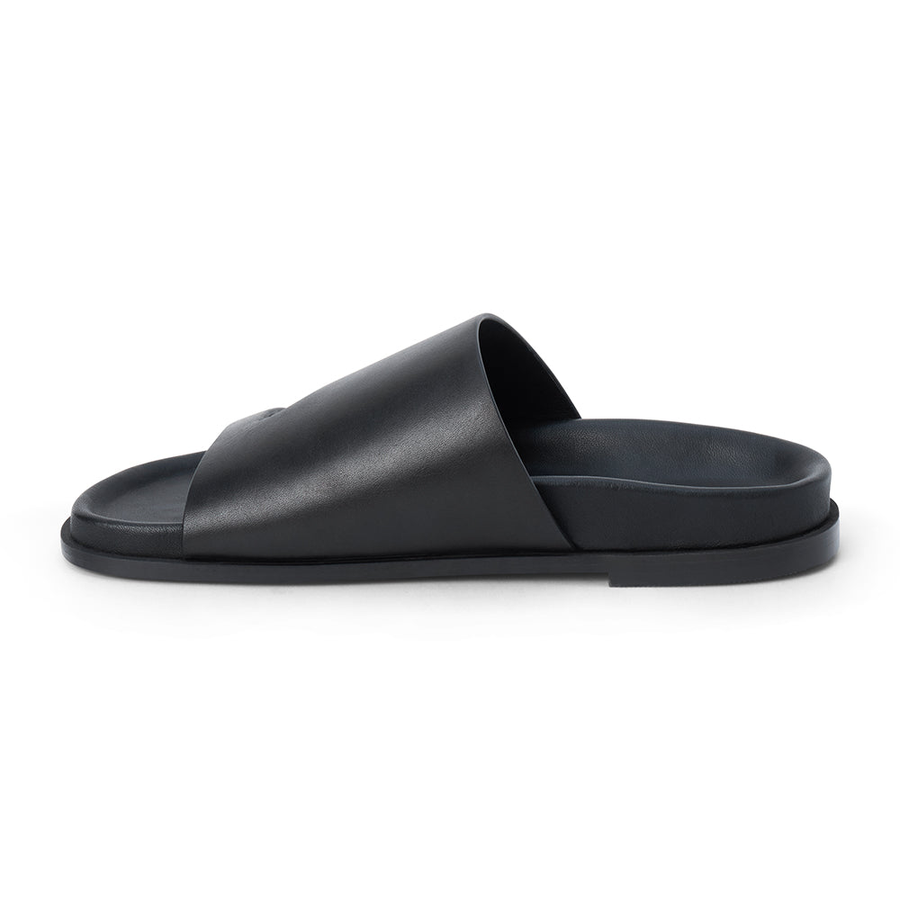 Black leather slide sandal with wide strap and open toe shown on a white background.