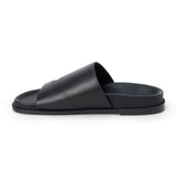 Black leather slide sandal with wide strap and open toe shown on a white background.