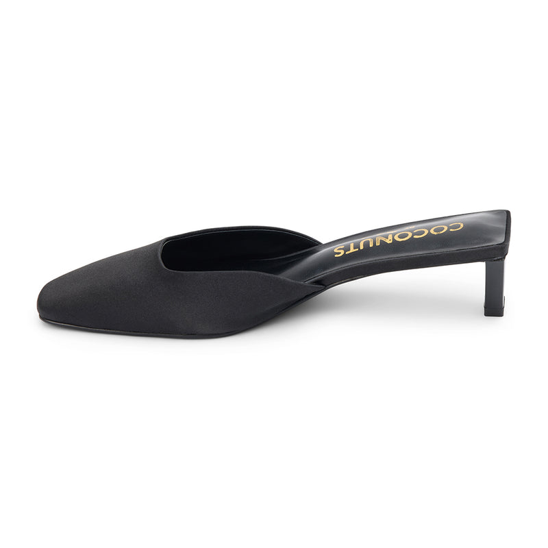 Black satin mule heels with a pointed toe and sleek slip-on design. A sophisticated staple for effortless elegance and modern styling.