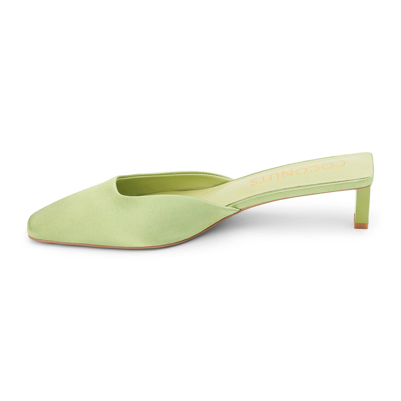 Soft green satin mule heels with a pointed toe and sleek slip-on design. A sophisticated staple for effortless elegance and modern styling.