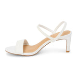 White strappy sandal with a slim heel and open toe, shown on a white background.