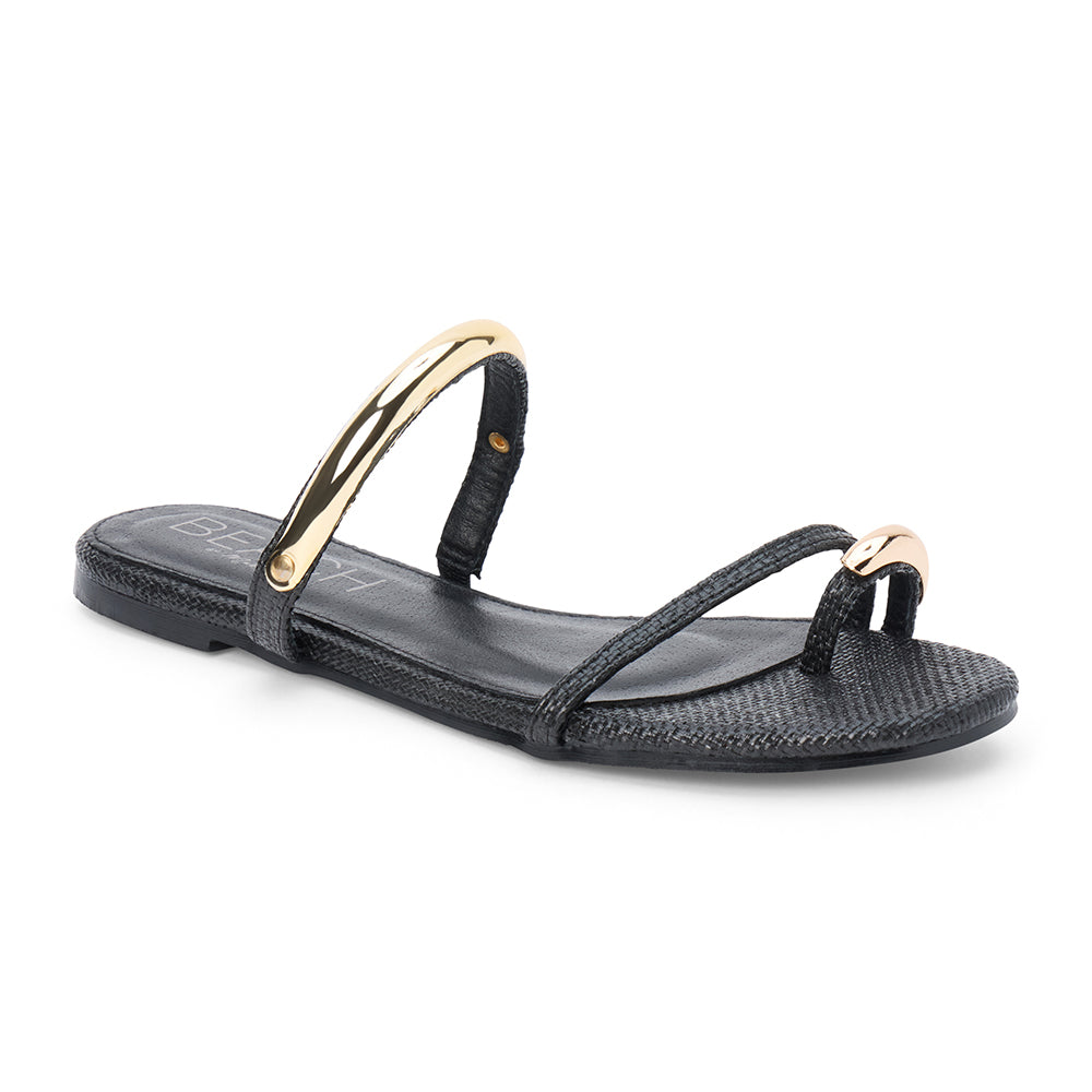 Black raffia flat sandal with slim straps and gold-tone hardware, shown on a white background.