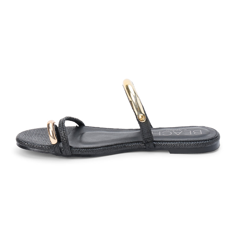 Black raffia flat sandal with slim straps and gold-tone hardware, shown on a white background.