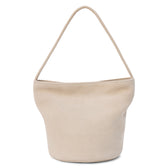 A beige suede bucket bag with a single shoulder strap and relaxed silhouette shown on a white background.
