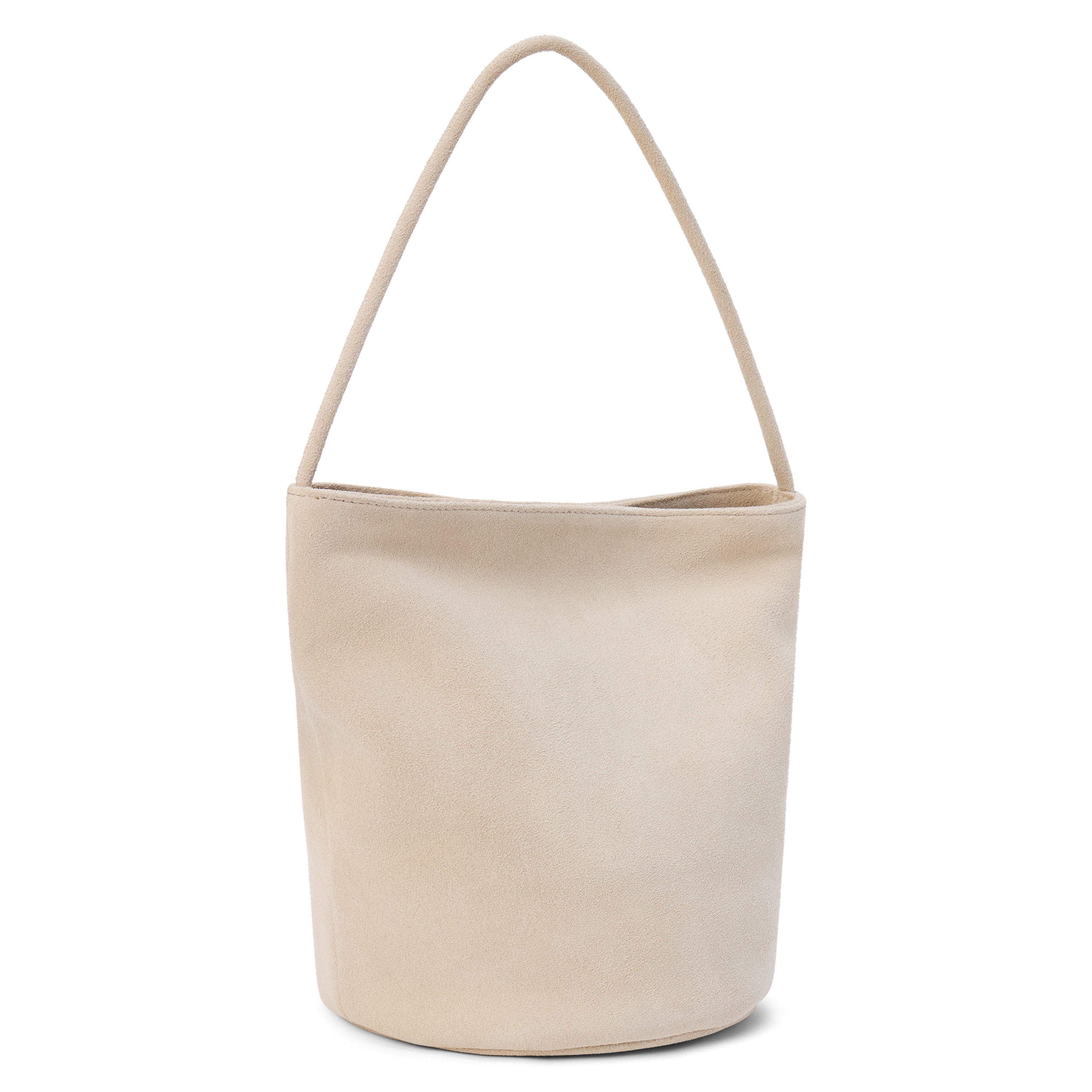 A beige suede bucket bag with a single shoulder strap and relaxed silhouette shown on a white background.