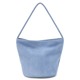 A blue suede bucket bag with a single shoulder strap and soft structure shown on a white background.