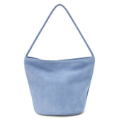 A blue suede bucket bag with a single shoulder strap and soft structure shown on a white background.