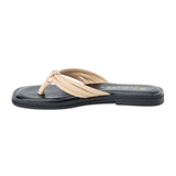 Beige leather flip flop sandal with multiple tubular straps gathered in a knotted design and a flat sole shown on a white background.