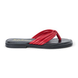 Red leather flip flop sandal with multiple tubular straps gathered in a knotted design and a flat sole shown on a white background.