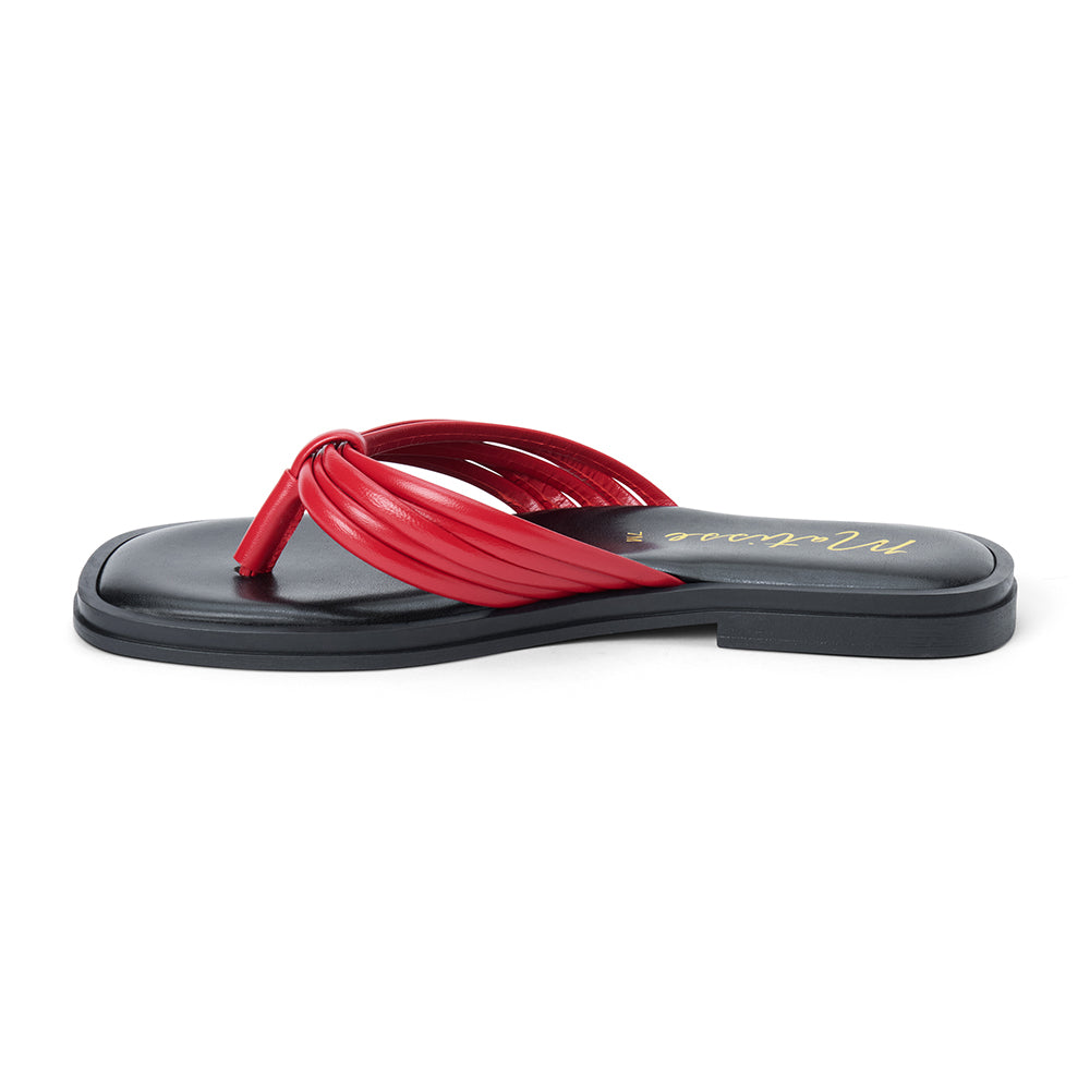 Red leather flip flop sandal with multiple tubular straps gathered in a knotted design and a flat sole shown on a white background.