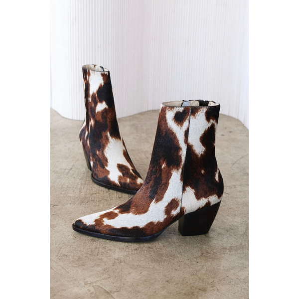Caty Ankle Boot – Matisse Footwear – Cow-print haircalf ankle boot with a pointed toe, stacked block heel, and side zipper. A bold Western-inspired silhouette with statement-making texture.