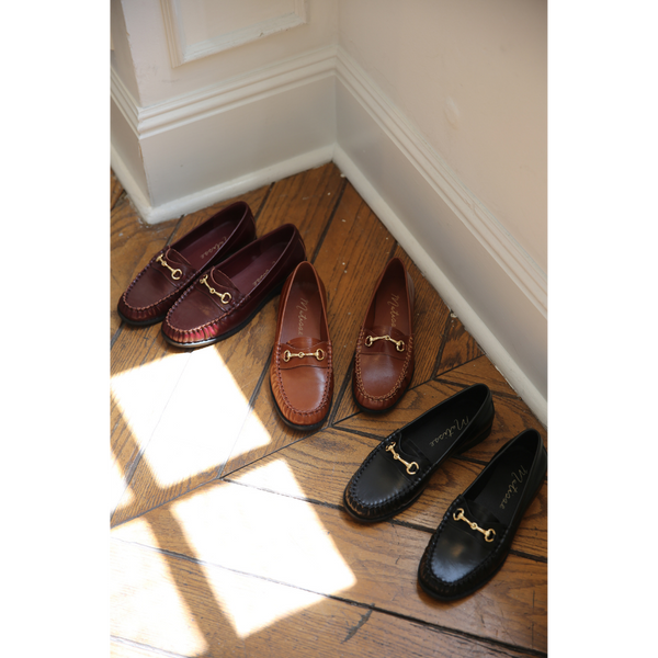 Three pairs of the Danny Loafer by Matisse on a wooden floor with sunlight casting shadows