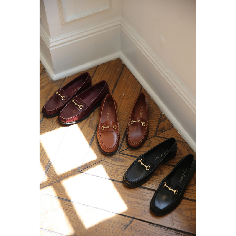 Three pairs of the Danny Loafer by Matisse on a wooden floor with sunlight casting shadows