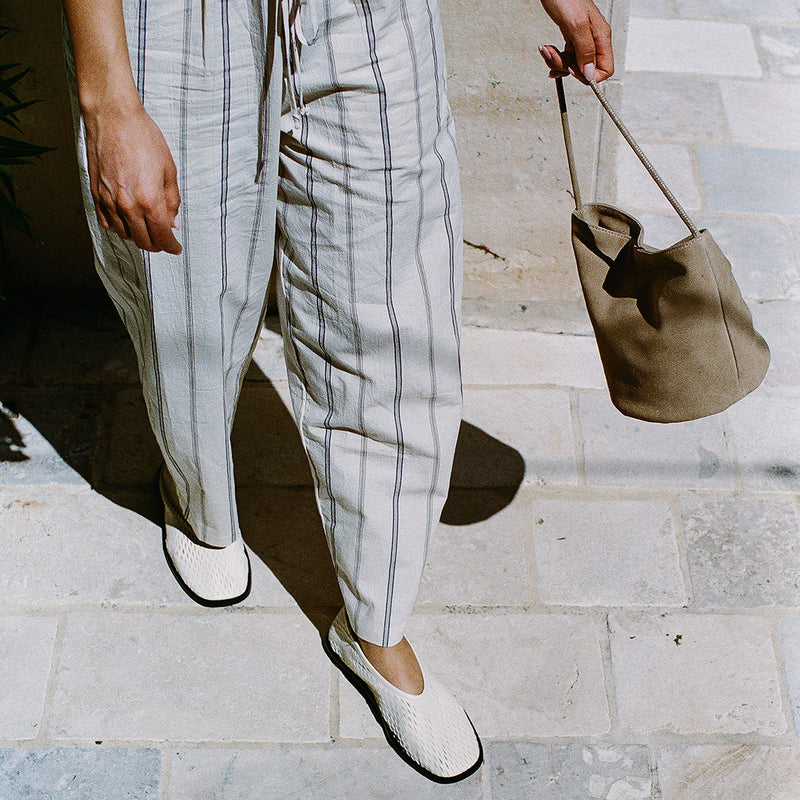 Vancouver Bucket Bag - Matisse Footwear - Minimalist bucket bag in soft beige colored suede with a seamless silhouette and a single shoulder strap. A versatile and unstructured carryall with effortless, elevated appeal.