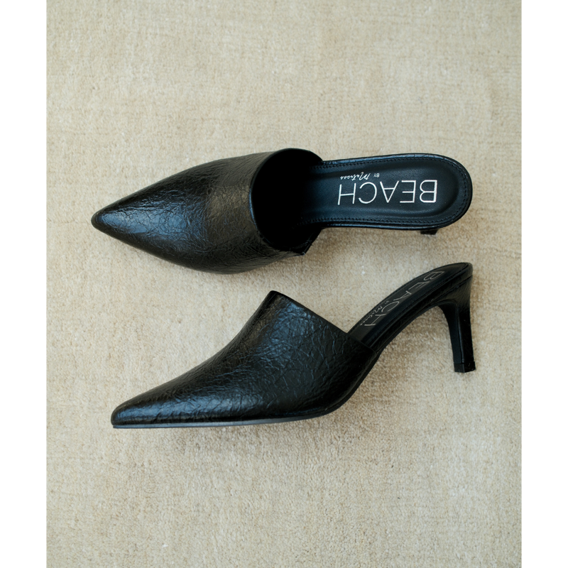 Garret Heeled Mule – Beach by Matisse – Black pointed-toe slip-on mule with textured finish and stiletto heel.