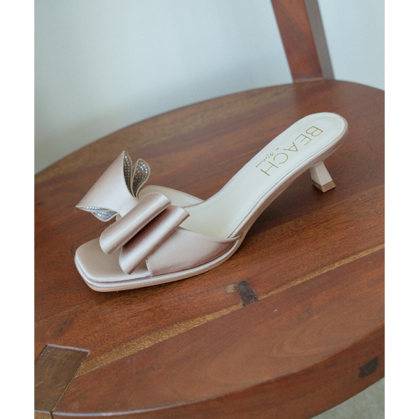 Holland Vegan Heeled Sandal – Beach by Matisse – Nude satin slip-on sandal with kitten heel and oversized double bow detail.