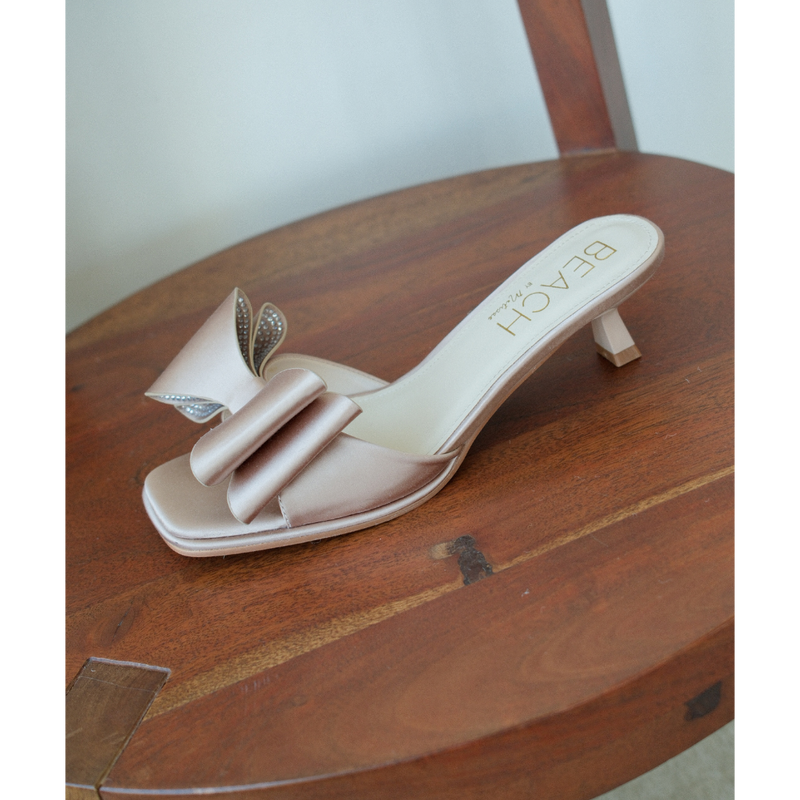 Holland Vegan Heeled Sandal – Beach by Matisse – Nude satin slip-on sandal with kitten heel and oversized double bow detail.