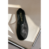 Black mesh slip-on shoe with 'Matisse' branding on a light surface.