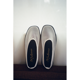 Pair of white mesh slip-on shoes with black soles on a white background, featuring 'Matisse' branding.