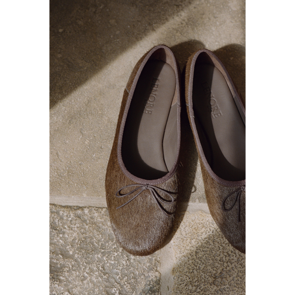 Marie Ballet Flat - Lenore by Matisse - Brown cow hair ballet flats with a classic round-toe silhouette, delicate bow detail, and padded leather insole. A timeless essential for effortless everyday elegance.