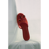 Red mesh slipper with floral embellishments on a white background.