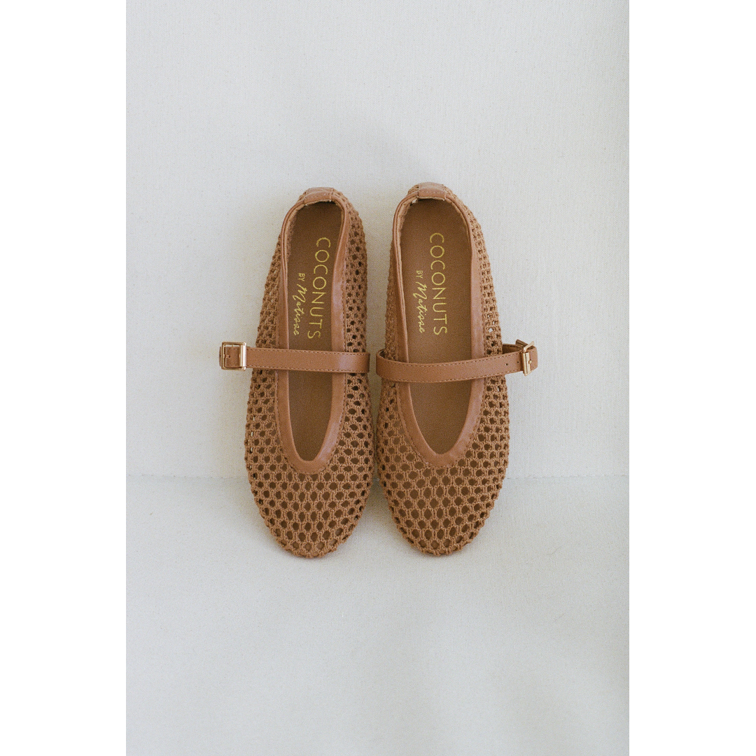 Pair of tan woven Nolita Ballet Flats with a strap on a light gray background.