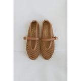 Pair of tan woven Nolita Ballet Flats with a strap on a light gray background.