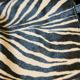 close up of brown and black zebra print tote bag