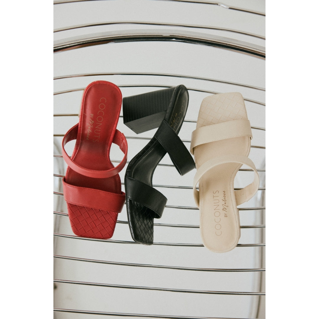 Three women's heeled sandals in red, black, and beige on a striped background.