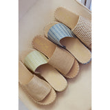 Set of five espadrille sandals with 'Beach by Matisse' branding on a beige cushion.

