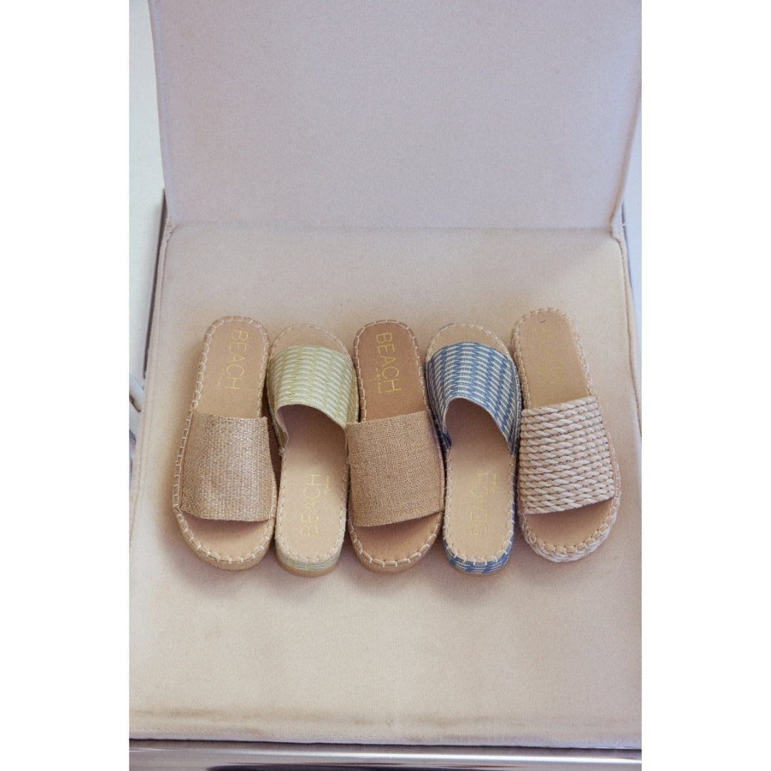 Set of five espadrille sandals with 'Beach by Matisse' branding on a beige cushion.
