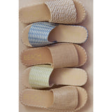 Stack of five espadrille sandals with 'Beach by Matisse' branding on a beige background.